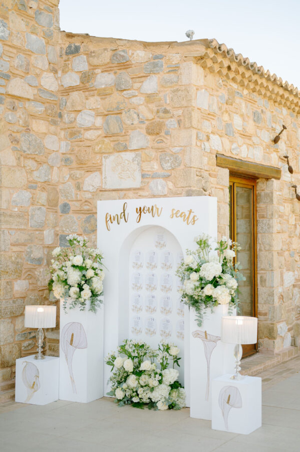 Luxury wedding details with white flowers and chandeliers at Pyrgos Petreza
