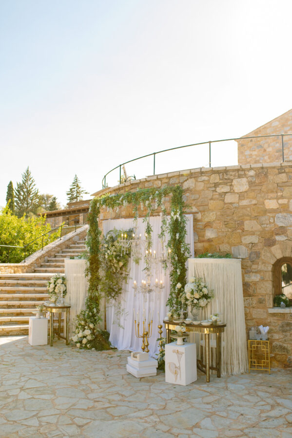 Luxury wedding details with white flowers and chandeliers at Pyrgos Petreza
