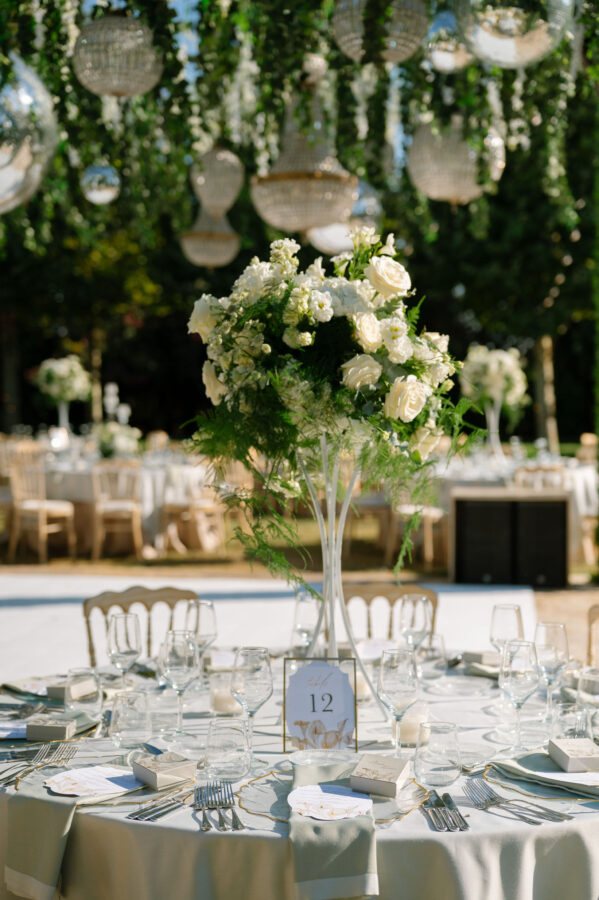 Wedding cake decorated with fresh flowers and greenery