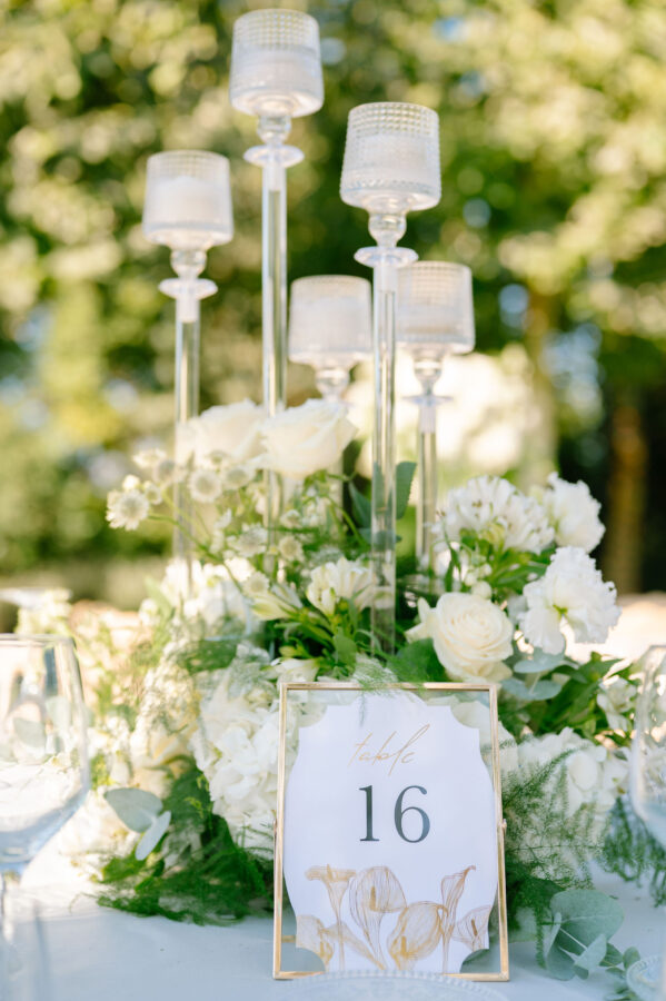 Wedding cake decorated with fresh flowers and greenery