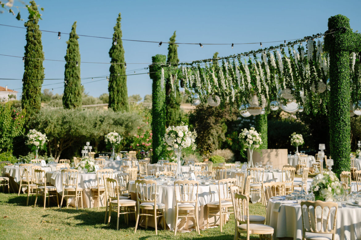 Luxury wedding details with white flowers and chandeliers at Pyrgos Petreza