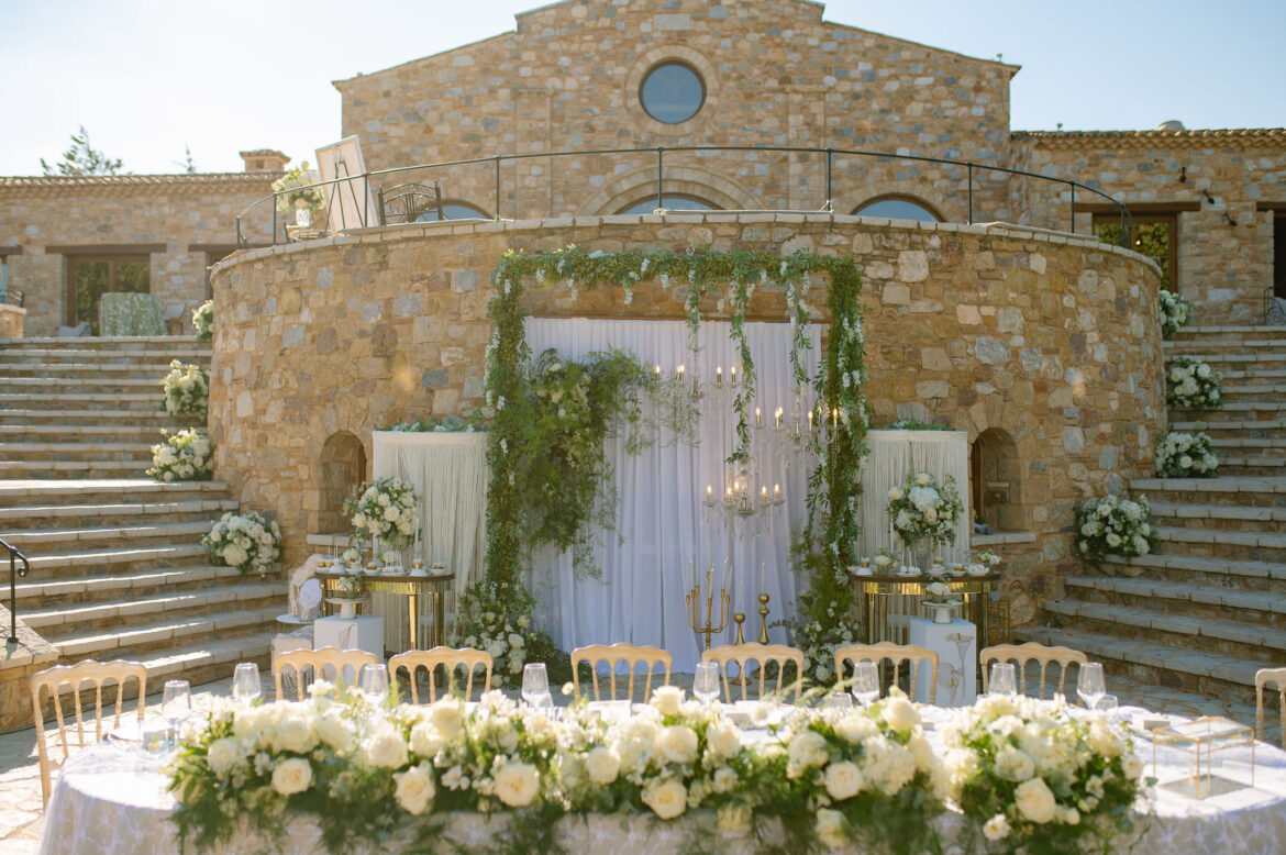 Wedding cake decorated with fresh flowers and greenery