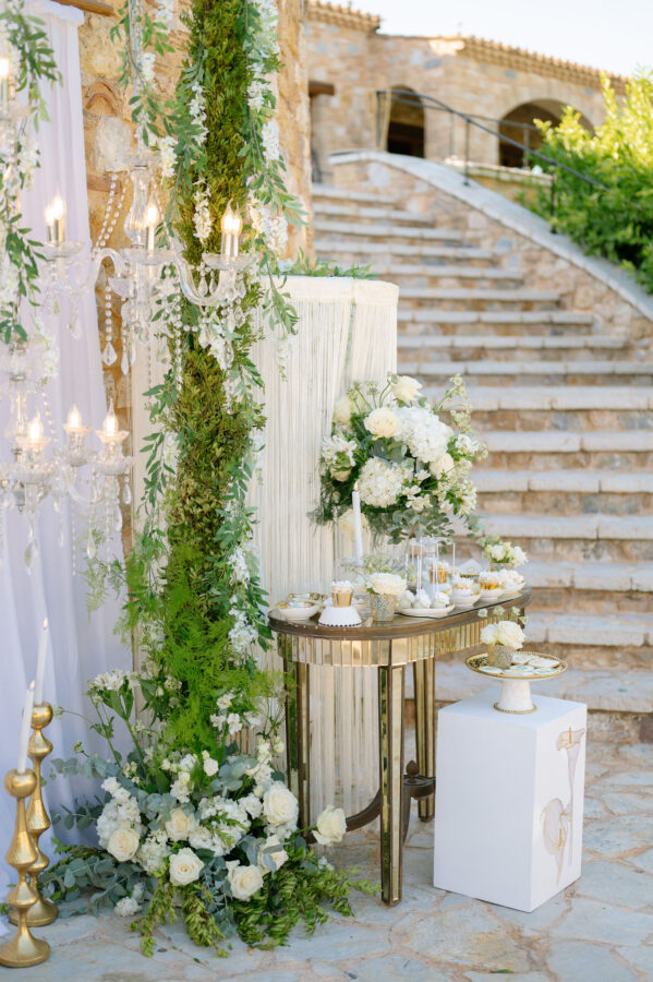 Luxury wedding details with white flowers and chandeliers at Pyrgos Petreza